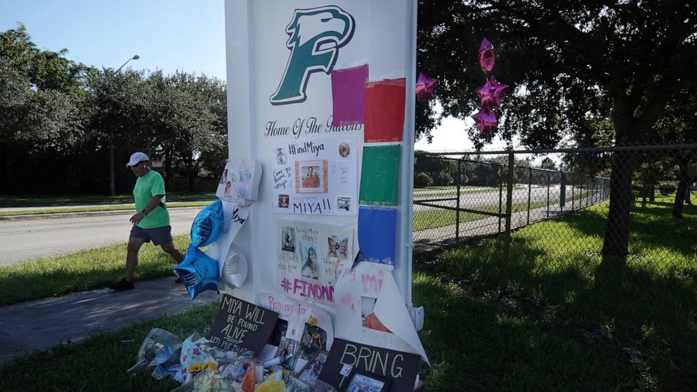 Flowers adorn a memorial for slain college student Miya Marcano at Flanagan High School in Pembroke Pines, Fla., Monday, Oct. 4, 2021. Authorities say they've found the body of a missing Florida college student who disappeared a week ago. Orange Coun