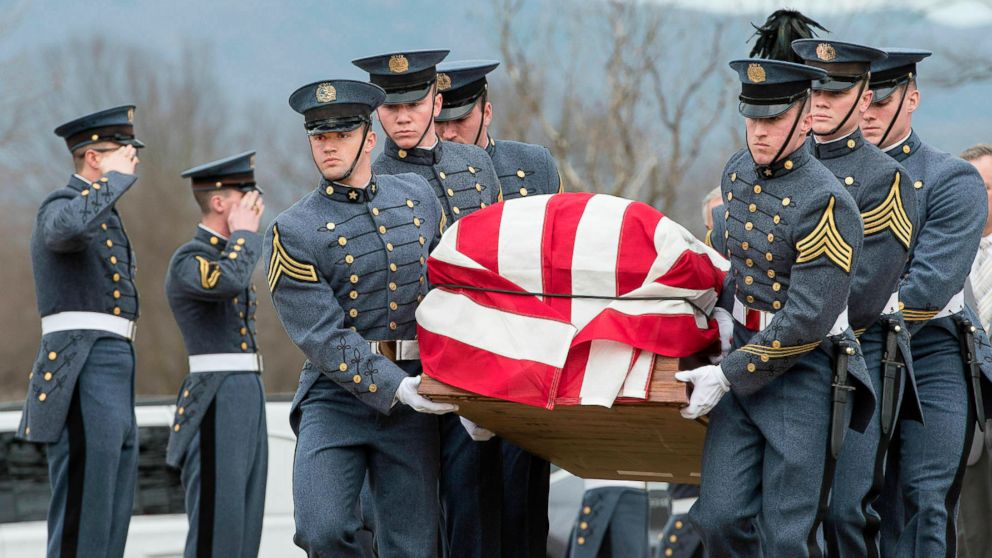 In this Friday, Feb. 15, 2019 photo, VMI cadets carry the flag-draped coffin of former Secretary of the Army John Marsh Jr. outside New Market Battlefield State Historical Park during his funeral in New Market, Va. Marsh, who also served four terms a