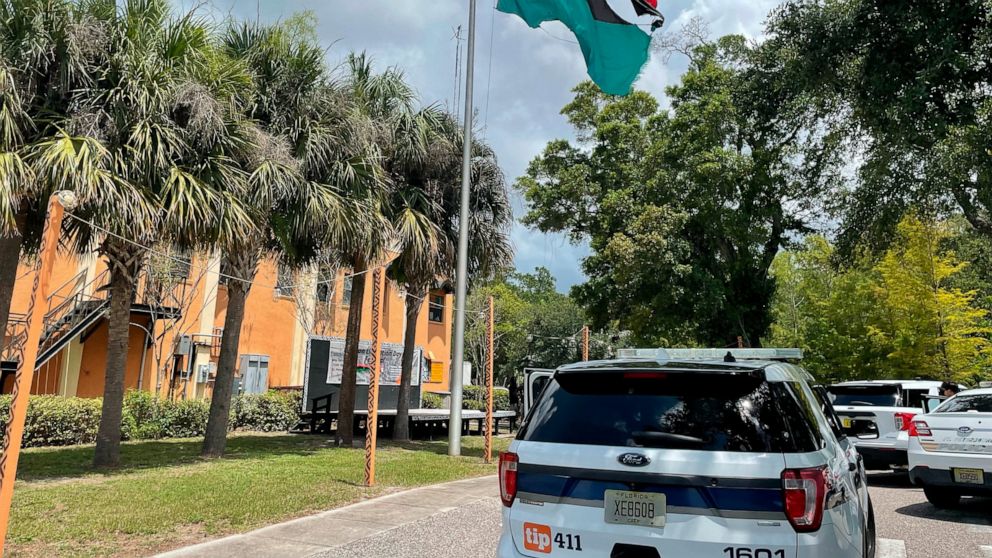 In this photo provided by Burning Spear Media, LLC, a damaged Pan-African flag flies outside the headquarters of the Uhuru Movement, a Black international socialist group based in St. Petersburg, Fla., Saturday, July 2, 2022. Earlier in the day, pers