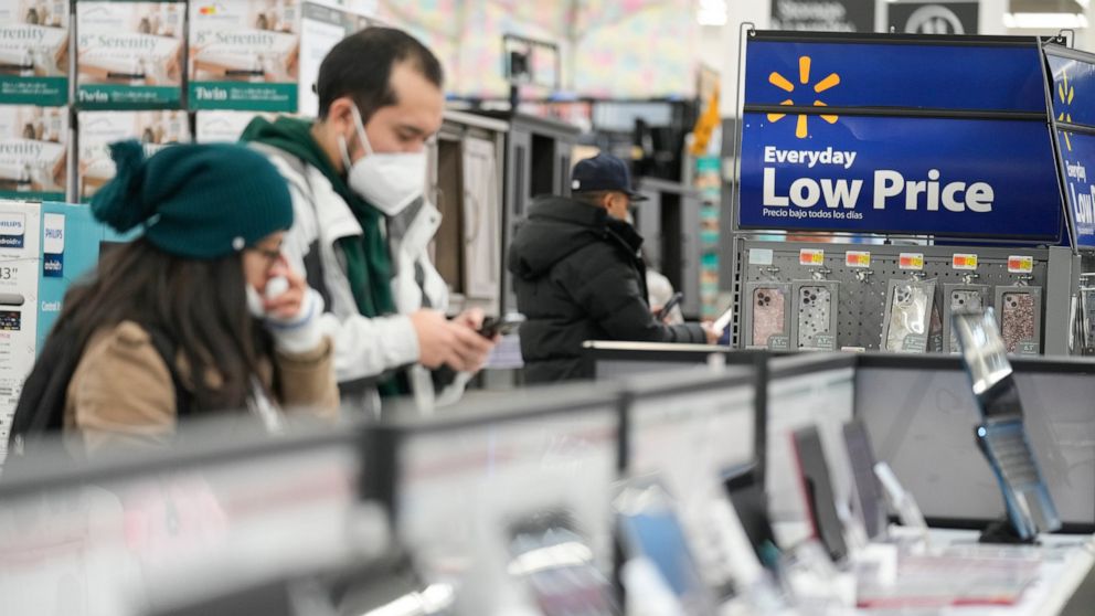 FILE - Signs advertise deals and low prices at a Walmart in Secaucus, N.J., Tuesday, Nov. 22, 2022. On Tuesday the Conference Board reports on U.S. consumer confidence for November. (AP Photo/Seth Wenig, File)
