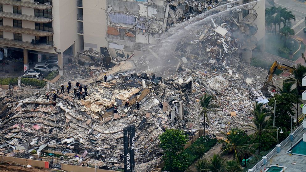 FILE - In this Friday, June 25, 2021, file photo, rescue workers work in the rubble at the Champlain Towers South Condo in Surfside, Fla. The fight over whether the site of June's deadly Florida condominium collapse should be sold for development or 