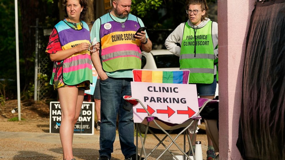 Clinic escorts stand by the parking lot entrance to direct patients and deflect any interference from anti-abortion protestors at the Jackson Women's Health Organization (JWHO), Mississippi's last remaining abortion clinic, Tuesday, May 3, 2022, in J