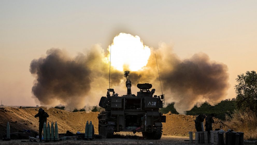 FILE - In this May 19, 2021, file photo, an Israeli artillery unit fires shells towards targets in Gaza Strip, at the Israeli Gaza border. Israel is at war with Hamas, Jewish-Arab mob violence has erupted inside Israel, and the West Bank is experienc