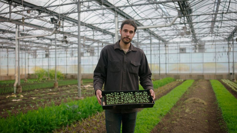 In this photo provided by the Rockefeller Foundation, Jason Grauer, the Seed and Crop Director at Stone Barns, poses for a photo at Stone Barns’s greenhouse on April 7, 2021, in Tarrytown, N.Y. Rockefeller grantee Stone Barns Center for Food and Agri