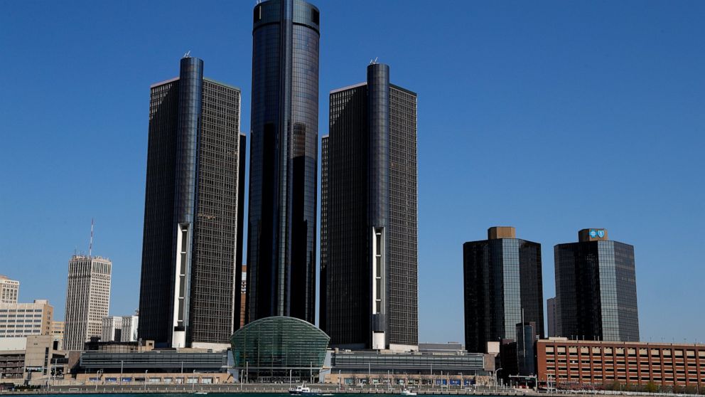 FILE - This May 12, 2020, file photo, shows a general view of the Renaissance Center, headquarters for General Motors, along the Detroit skyline from the Detroit River. General Motors will keep its headquarters in the sparsely populated seven-buildin