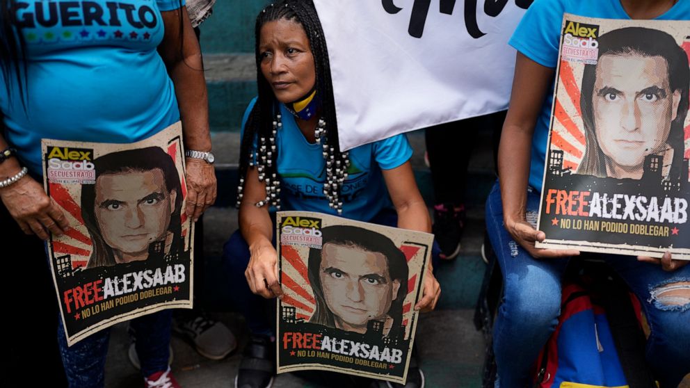 Demonstrators hold posters with the image of Alex Saab who has been extradited to the U.S., during a demonstration demanding his release, in the Petare neighborhood of Caracas, Venezuela, Monday, April 4, 2022. Saab, a close ally of Venezuela's Presi