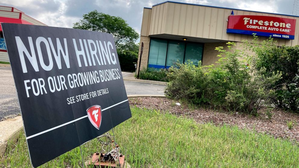 A hiring sign is displayed at Firestone Complete Auto Care store in Arlington Heights, Ill., Wednesday, June 30, 2021. Illinois Governor J.B. Pritzker said that the state may join the list of others that may consider offering incentives for people to