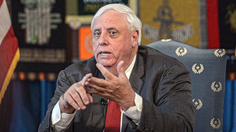 FILE - In this March 12, 2020, file photo, West Virginia Gov. Jim Justice speaks during a news conference at the State Capitol in Charleston, W.Va. Justice said that 745 of the record 893 people hospitalized, or 85%, for the coronavirus on Wednesday,