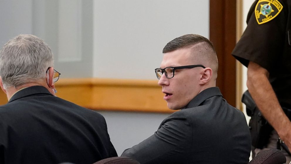 FILE - Volodymyr Zhukovskyy, of West Springfield, Mass., center right, charged with negligent homicide in the deaths of seven motorcycle club members in a 2019 crash, speaks with defense attorney Steve Mirkin, left, at Coos County Superior Court, in 