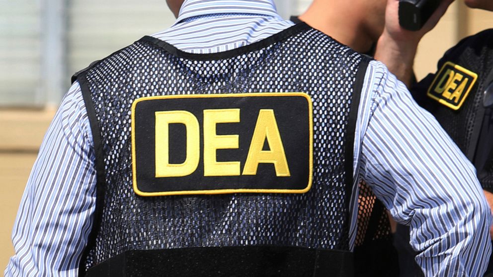 FILE - This June 13, 2016, file photo shows Drug Enforcement Administration agents in Florida. A current U.S. Drug Enforcement Administration agent and a former supervisor in the agency were indicted Friday, May 20, 2022 on federal charges accusing t