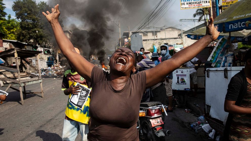 A woman shouts anti-government slogans during a protest organized by friends and relatives of Biana Velizaire, who was kidnapped and held for several days by gang members, in Port-au-Prince, Haiti, Monday, Sept. 27, 2021. Haitian police on Monday lau