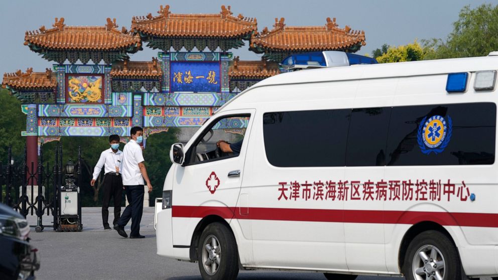 Security guards watch as a vehicle for the epidemic control center pulls up to the entrance into the Tianjin Binhai No. 1 Hotel where U.S. and Chinese officials are expected to hold talks in Tianjin municipality in China Monday, July 26, 2021. Americ