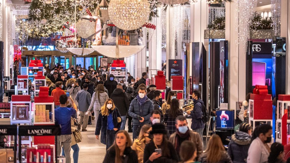 Black Friday shoppers walk through Macy's on Friday, Nov. 26, 2021, in New York. Retailers are expected to usher in the unofficial start to the holiday shopping season today with bigger crowds than last year in a closer step toward normalcy. But the 