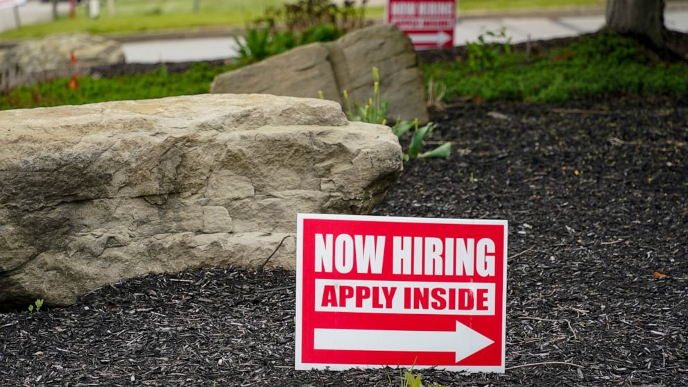 This May 5, 2021 photo shows hiring signs posted outside a gas station in Cranberry Township, Butler County, Pa. The number of Americans applying for unemployment benefits dropped last week, reported Thursday, June 24, a sign that layoffs declined an
