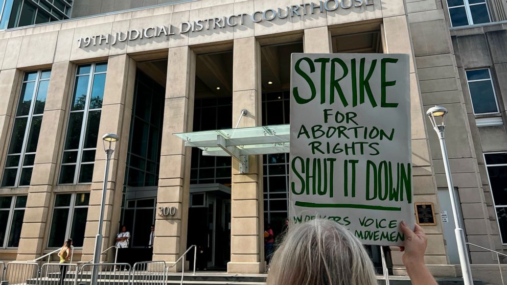 An abortion rights advocate demonstrates outside the 19th Judicial District Courthouse, Monday July 18, 2022, in Baton Rouge, La. (AP Photo/Stephen Smith)