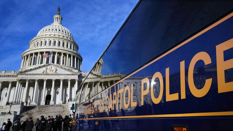 FILE - A large group of police arrive on a bus at the Capitol, Thursday, Jan. 6, 2022, in Washington. Thomas Smith, a U.S. Capitol Police officer, was indicted on federal civil rights charges after he was involved in an unauthorized high-speed chase,
