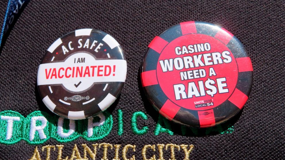FILE - Buttons are pictured on the shirt of a casino worker in Atlantic City, N.J., on April 29, 2022, in support of efforts by their union to obtain a "significant" wage increase in contract talks currently underway. If unable to reach a new contrac