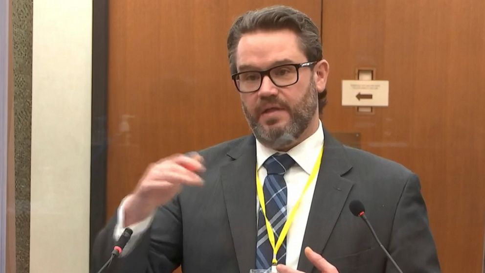 In this image from video, defense attorney Eric Nelson questions Dr. Andrew Baker, Hennepin County Chief Medical Examiner, as Hennepin County Judge Peter Cahill presides Friday, April 9, 2021, in the trial of former Minneapolis police Officer Derek C