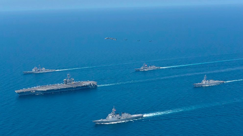This photo provided by Japan Maritime Self-Defense Force shows USS Abraham Lincoln, left, and JS Kongo, front, sail in formation during a U.S.-Japan bilateral exercise at the Sea of Japan on April 12, 2022. U.S. and Japanese warships, led by the USS 