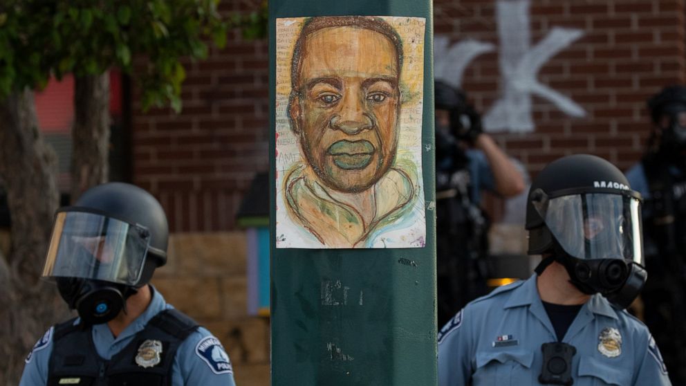 FILE - Minneapolis police stand outside the department's 3rd Precinct on May 27, 2020, in Minneapolis. Almost two years after George Floyd died at the hands of four Minneapolis police officers, Minnesota's Department of Human Rights was set Wednesday
