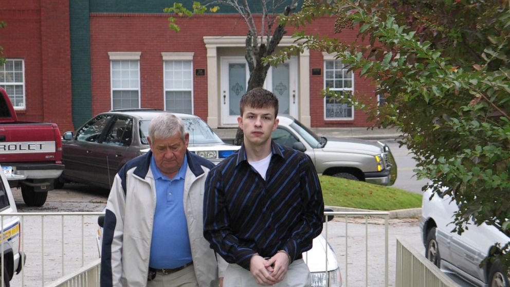 In this Oct. 20, 2006 photo, Evan Miller, right, is escorted to the Lawrence County Courthouse in Moulton, Ala. A judge is set to decide the punishment for the Alabama man, sentenced to life in prison for a murder he committed at age 14, and whose ca