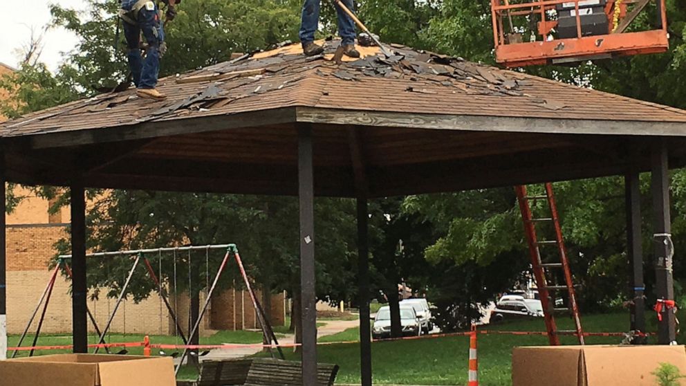 FILE - In this Wednesday, Sept. 14, 2016 file photo, workers scrape shingles from the gazebo where 12-year-old Tamir Rice was fatally shot by a Cleveland police officer, as crews prepare to dismantle the gazebo at a recreation center on the west side