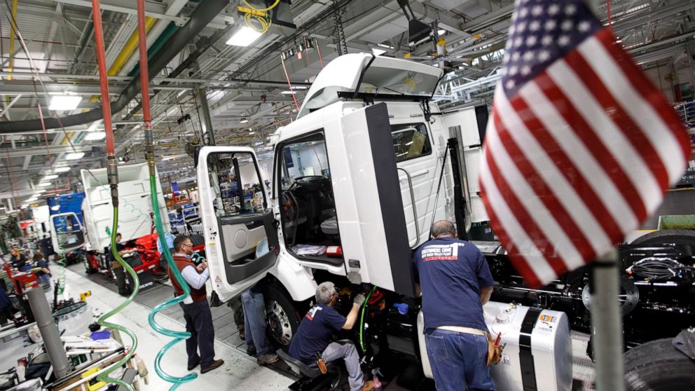 FILE - In a Jan. 6, 2011, file photo, workers install parts on a truck on the Volvo truck assembly line at the Volvo plant in Dublin, Va. Striking blue-collar workers at the Volvo heavy truck plant in southwestern Virginia narrowly ratified what the 