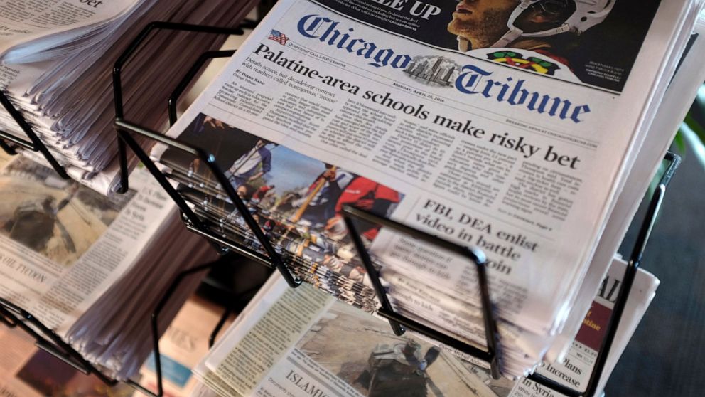 FILE - In this Monday, April 25, 2016, file photo, Chicago Tribune and other newspapers are displayed at Chicago's O'Hare International Airport. Shareholders of Tribune Publishing, one of the country’s largest newspaper chains, will vote Friday, May 