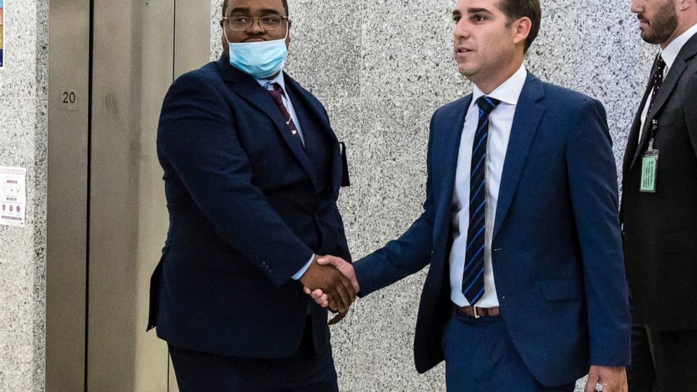 FILE - Eliseo DeLeon, left, is greeted by his lawyer Cary London in the hallway at the Kings County Supreme Court in the Brooklyn borough of New York on Wednesday Aug. 31, 2022. DeLeon was sentenced Thursday, Sept. 15, 2022, to 20 years to life for t