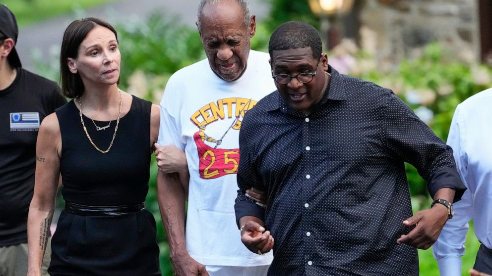 FILE - Bill Cosby, center, and spokesperson Andrew Wyatt, right, and attorney Jennifer Bonjean, left, approach members of the media gathered outside Cosby's home in Elkins Park, Pa., on June 30, 2021. An Illinois judge could be facing discipline afte