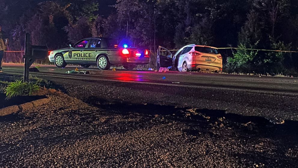 This photo provided by The Indiana State Police, police investigate a shooting late Monday, May 16, 2022 near Palmyra, Ind. Two men were fatally shot after a police officer and two good Samaritans stopped along a southern Indiana highway to help a dr