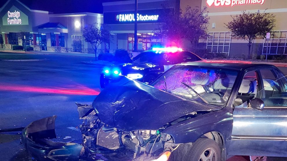 A crashed vehicle is seen in Reno, Nev., early Saturday, Oct. 1, 2022. Hundreds of cars took over northern Nevada parking lots and intersections Friday night Sept. 30, and into Saturday, Oct. 1, 2022, performing stunts in souped-up vehicles and leadi