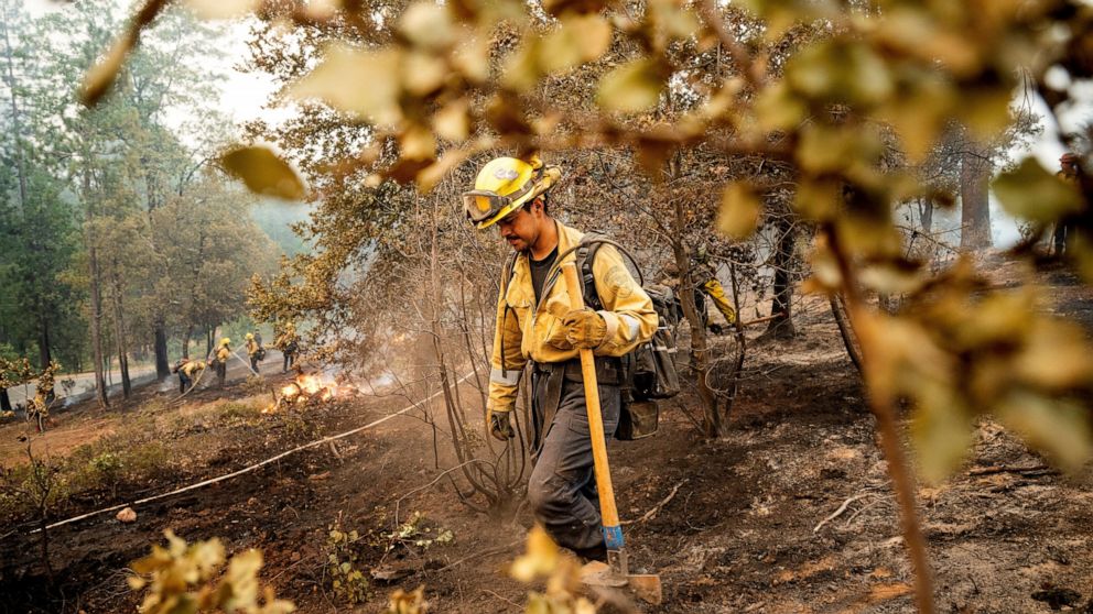Firefighter Sergio Porras mops up hot spots while battling the Oak Fire in the Jerseydale community of Mariposa County, Calif., on Monday, July 25, 2022. He is part of Task Force Rattlesnake, a program comprised of Cal Fire and California National Gu