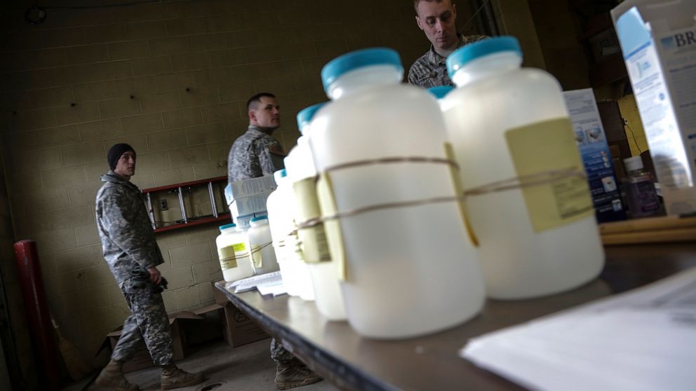 FILE - In this Jan. 18, 2016 file photo, water analysis test kits for Flint, Mich., residents to pick up for lead testing in their drinking water are set out on a table at Flint Fire Department Station No. 1 in Flint. Former Michigan Gov. Rick Snyder
