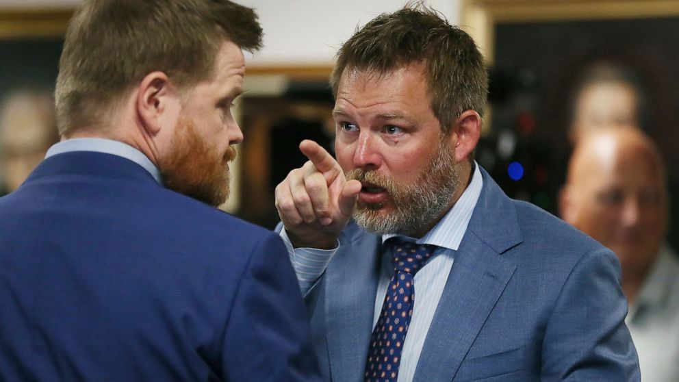 Wesley Ball speaks to Mark Bankston, lawyers representing Neil Heslin and Scarlett Lewis, parents of Sandy Hook shooting victim Jesse Lewis, during trial at the Travis County Courthouse in Austin, Wednesday Aug. 3, 2022. Jones testified Wednesday tha