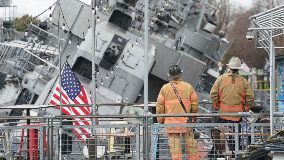 The vintage ship USS The Sullivans is listing to one side after taking on water overnight, Thursday, April 14, 2022 in Buffalo, N.Y. Crews were working to stabilize the decommissioned World War II-era destroyer and keep the 79-year-old vessel from si