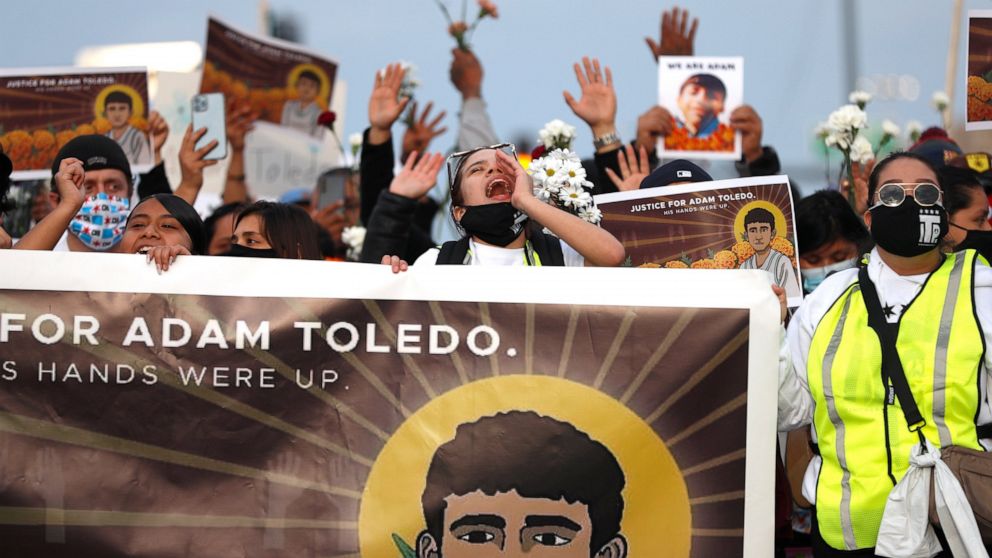 Demonstrators attend a peace walk honoring the life of police shooting victim 13-year-old Adam Toledo, Sunday, April 18, 2021, in Chicago's Little Village neighborhood. (AP Photo/Shafkat Anowar)