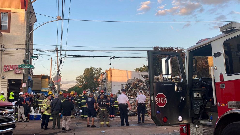 This photo provided by the Philadelphia Fire Dept., emergency personnel respond to the scene of a building that caught fire then collapsed early Saturday, June 18, 2022 in Philadelphia. The Philadelphia Fire Department said “several” firefighters and