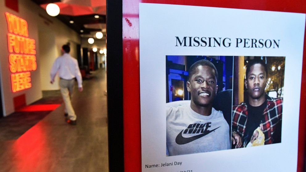 Illinois State University students walk past a poster seeking the whereabouts of Jelani Day near the Dean of Students office in Illinois State University's Bone Student Center in Normal, Illinois, Thursday, Sept. 23, 2021. Day's body washed up on the