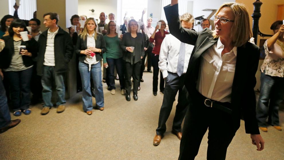 FILE - Star Tribune editor Nancy Barnes, gives a toast to Star Tribune reporters Brade Schrade, Jeremy Olson and Glenn Howatt along with editorial cartoonist Steve Sack after the newspaper won two Pulitzer Prizes on April, 15, 2013, in Minneapolis. T