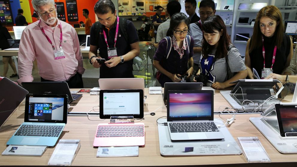FILE - Visitors review new Asus computer products at the Computex trade show in Taipei, Taiwan, Tuesday, June 2, 2015. The U.S. government has announced talks with Taiwan, Thursday, Aug. 18, 2022, on a trade treaty in a new sign of support for the se