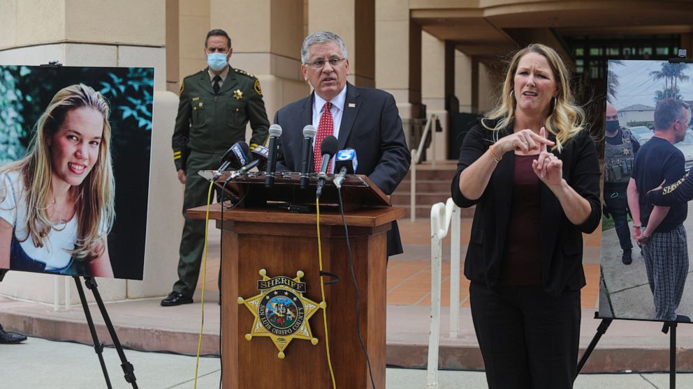FILE - In this April 13, 2021, file photo, Cal Poly President Jeffrey Armstrong, center, speaks during a news conference in San Luis Obispo, Calif. At left is a photo of student Kristin Smart. A California judge is expected to rule Wednesday, Sept. 2