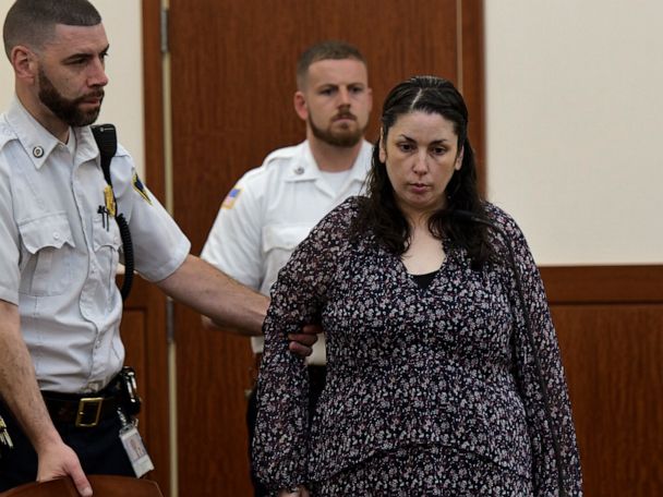 Erika Murray, charged in the deaths of two babies whose remains were found in her squalid home, is led into Superior Court, Thursday, June 20, 2019, in Worcester, Mass. (Rick Cinclair/Worcester Telegram & Gazette via AP)