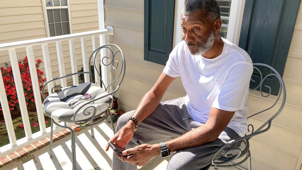 Tracey Howard, husband of Nicole Connors who was fatally shot on Thursday, Oct. 13, 2022, sits on the porch of his Raleigh, N.C., home on Friday, Oct. 14. On Thursday, a 15-year-old boy fatally shot two people in the streets of a middle-class Raleigh