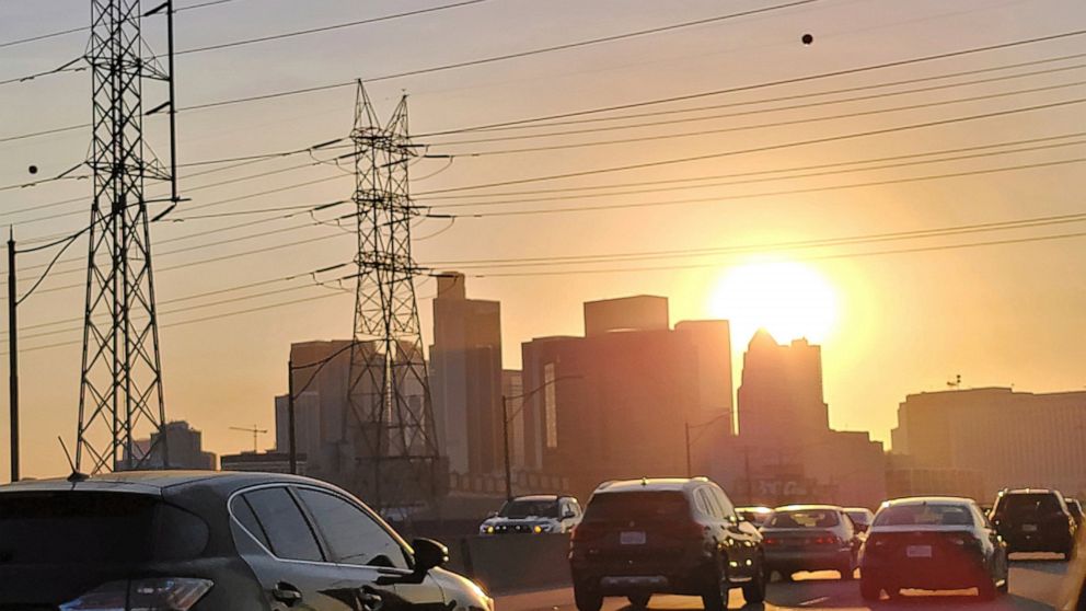 Vehicles travel near high power transmission towers in downtown Los Angeles, Tuesday, Sept. 6, 2022. As California stretched into its second week of excessive heat, the California Independent System Operator, the entity that oversees the state's elec