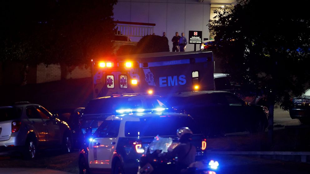 An ambulance believed to be carrying a shooting suspect arrives at Wake Medical Center Emergeny Room in Raleigh, N.C., Thursday, Oct. 13, 2022 surrounded by police. (AP Photo/Karl DeBlaker)