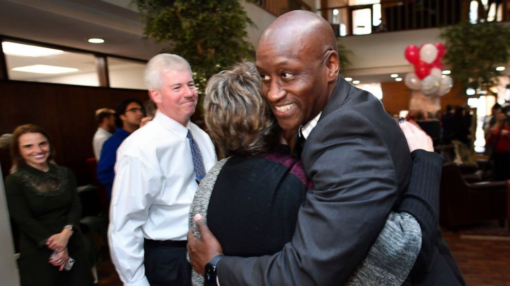 Charles Robinson is congratulated by associates after being hired as the chancellor of the University of Arkansas during an impromptu reception at the university's administration building on Wednesday, Nov. 16, 2022, in Fayetteville, Ariz. Robinson b