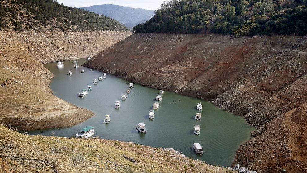 FILE - In this Oct. 30, 2014, file photo, houseboats float in the drought-lowered waters of Oroville Lake near Oroville, Calif. California’s hopes for a wet “March miracle” did not materialize and a dousing of April 2021 showers may as well be a mira