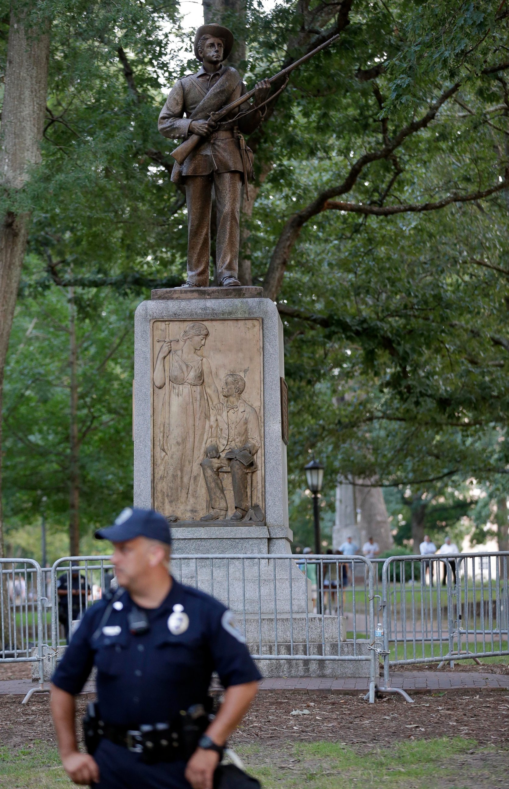FILE - In this Aug. 22, 2017, file photo, police stand by a Confederate monument nicknamed "Silent Sam" at the University of North Carolina-Chapel Hill in Chapel Hill, N.C. University of North Carolina-Chapel Hill Chancellor Carol Folt says the schoo