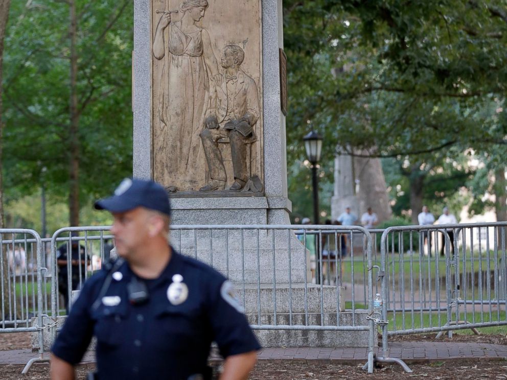 FILE - In this Aug. 22, 2017, file photo, police stand by a Confederate monument nicknamed Silent Sam at the University of North Carolina-Chapel Hill in Chapel Hill, N.C. University of North Carolina-Chapel Hill Chancellor Carol Folt says the schoo